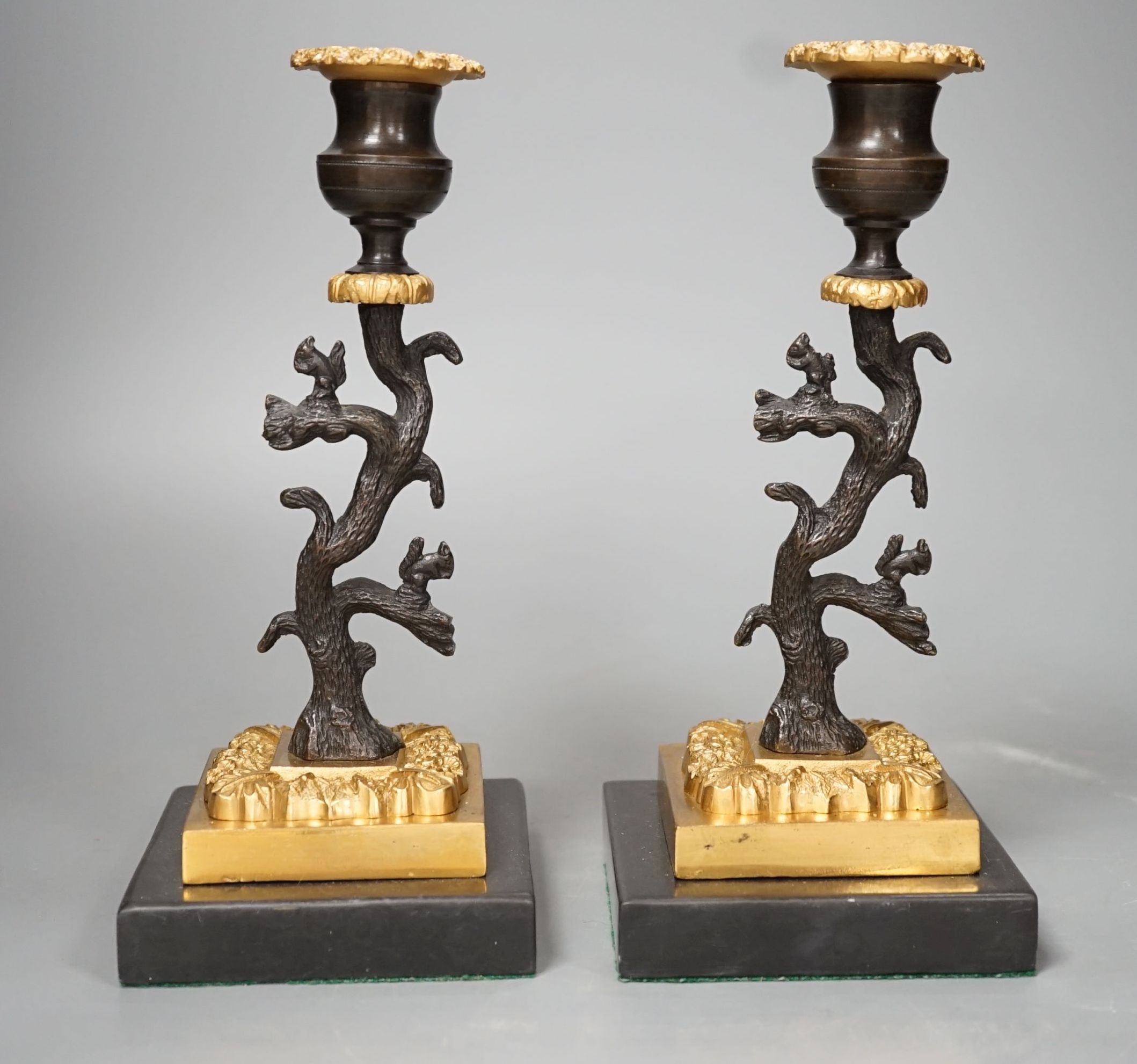 A pair of bronze and ormolu tree candlesticks - 22.5cm tall